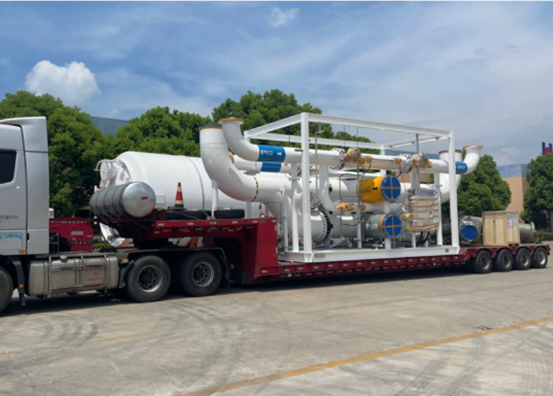 Large white process module loaded on a road trailer